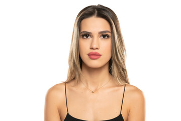 Naklejka premium beautiful young serious women with makeup and long hair on a white background.