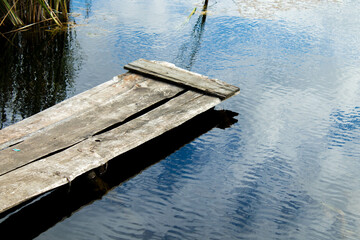 Naklejka premium small wooden pier on the lake, background