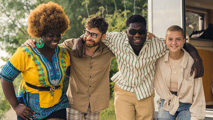 Multicultural group of young friends bonding outdoors and having fun. Motorhome concept. Equality in friendship and other human relationships. High quality photo