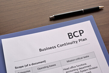 There is dummy documents that created for the photo shoot on the desk about Business Continuity...