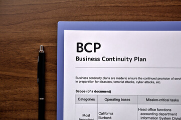 There is dummy documents that created for the photo shoot on the desk about Business Continuity...