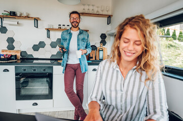 Couple working from home and spending time together in the kitchen