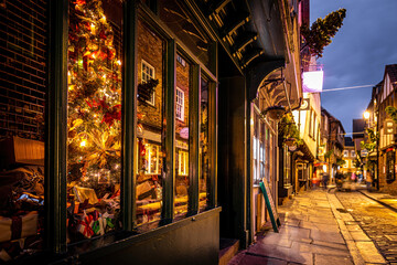 A Chirstmas night view of Shambles, a historic street in York featuring preserved medieval...