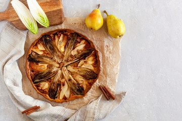 Homemade endive, pear and gorgonzola tart, flatlay, copy space