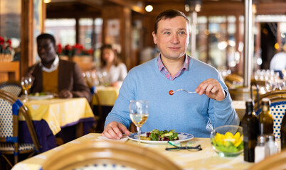 Portrait of a man who lies in a restaurant hall