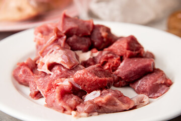 fresh raw sliced meat on a white plate