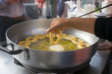 Picarones are ring-shaped fried sweets made with wheat flour dough mixed with pumpkin, and sometimes sweet potato, bathed in flavored chancaca honey. It is a traditional dish of the Peruvian and Chile
