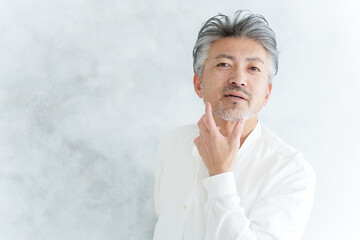 髭を整えるグレイヘアの男性