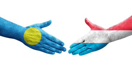 Handshake between Luxembourg and Palau flags painted on hands, isolated transparent image.