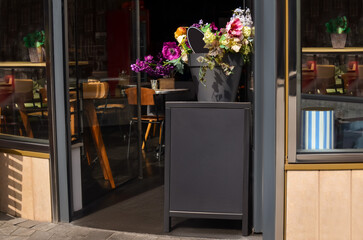 Entrance of cafe with potted flowers outdoors