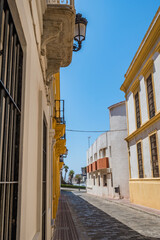 Fototapeta na wymiar Cobblestone street perspective with architecture and balconies and street lamp, Tarifa SPAIN