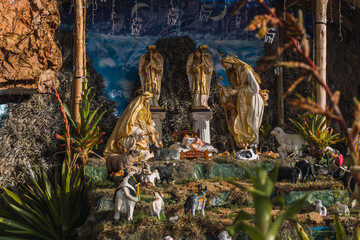Life size decoration with statues of holy family of jesus, surrounded with animals and plants.