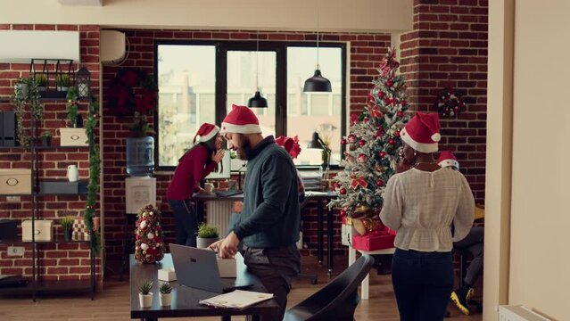 Upset depressed man getting fired from work on christmas eve, feeling sad and frustrated about career failure. Packing office belongings before leaving job, unhappy jobless dismissal.