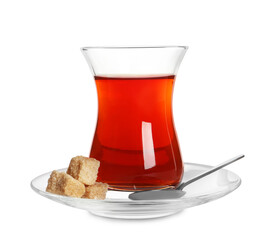 Glass of traditional Turkish tea with sugar cubes and spoon isolated on white