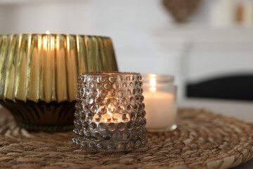 Burning candles in beautiful glass holders on table indoors, closeup. Space for text