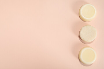 Set of solid shampoo bars on pink background, flat lay. Space for text