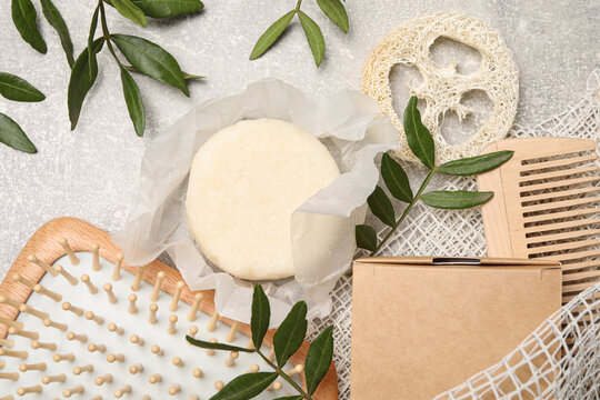 Flat lay composition with solid shampoo bar on light grey table