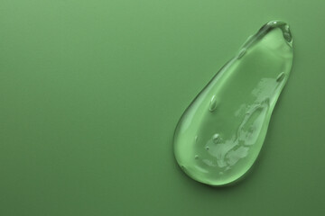 Sample of gel on green background, top view. Space for text