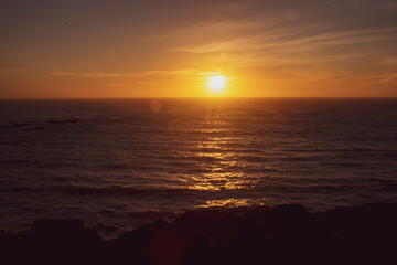 Fototapeta na wymiar Sun setting over the Oregon Coastline at Devil's Punchbowl Natural Area. 