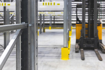 Modern large warehouse space interior, new and modern distribution storage with rows of empty high shelves and racks, concrete and steel, logistics complex inside