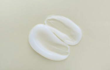 Sample of body cream on light background, top view