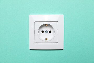 Power socket on turquoise wall. Electrical supply