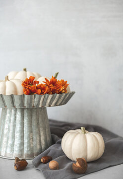 White Ghost Pumpkins on a Pedestal with Orange Chrysanthemums