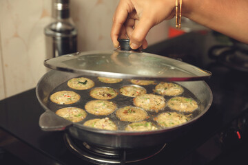 South Indian traditional food spicy Chettinadu kuzhi paniyaram is being prepared	
