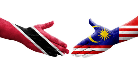 Handshake between Malaysia and Trinidad Tobago flags painted on hands, isolated transparent image.