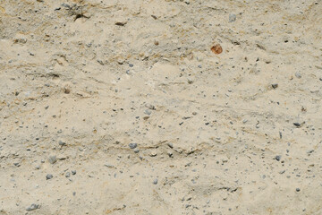 An abstract image of the texture of yellow sand and rock combined.