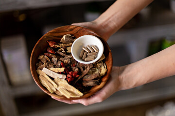 Chinese Herbs with Herbal Pills in a wooden bowl. Natural and organic 