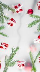 New Year's background for stories, format 16:9. gifts in red wrapping paper and Christmas tree branches in a multi-layered design, on a white background.