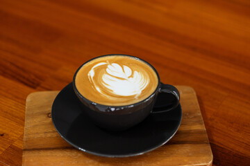 hot latte art coffee on wood table, relax time