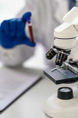 Laboratory assistant picks up an experimental blood vessel. Medical researchers wear rubber gloves to protect against germs. Show the blood vessels of patients undergoing laboratory research experimen