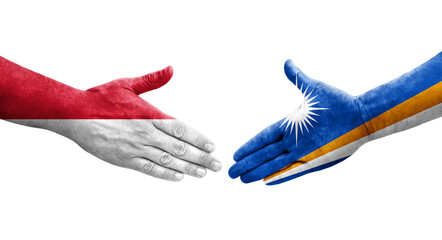 Handshake between Marshall Islands and Monaco flags painted on hands, isolated transparent image.