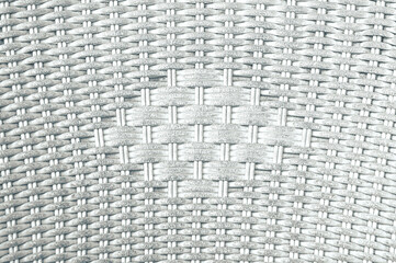 abstract background of braided wicker chair, with grooves in black contrasting with white