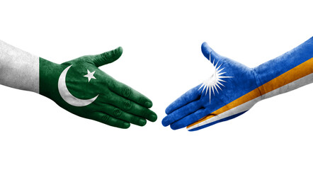 Handshake between Marshall Islands and Pakistan flags painted on hands, isolated transparent image.