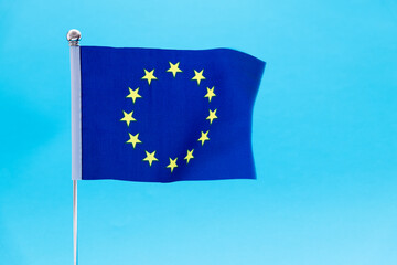European Union flag waving on blue background