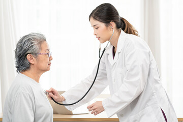 Female Doctor using stethoscope to check up a Asian senior woman and talking about treatment, Healthcare medicine, age, support, health care and people concept 