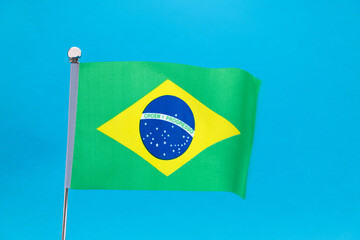 Brazilian flag waving on blue background