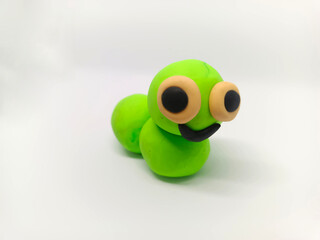 worm in clay by the kids playing by self. It's green cute worm and fun.