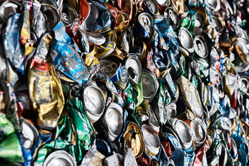Pressed tin cans from drinks at recycling plant macro view
