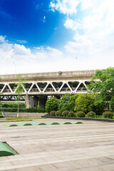 Fototapeta premium Concrete structure and asphalt road space under the overpass in the city
