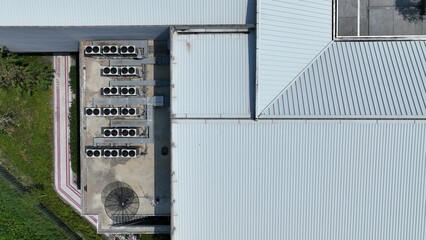 Bird eye view of many rooftop air compressor unit working slowly and hard on white metal sheet rooftop