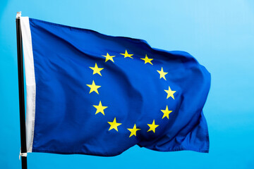 European Union Flag waving on blue background