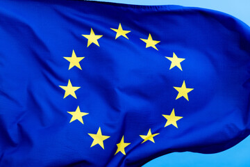European Union Flag waving on blue background