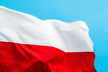 Poland flag waving on blue background