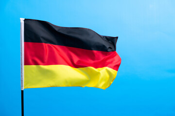 Germany flag waving on blue background