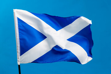 Scottish flag waving on blue background