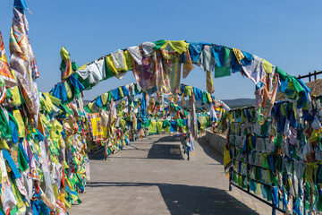 Fototapeta premium Prayer alley, densely filled with prayer flags on the territory of the datsan 